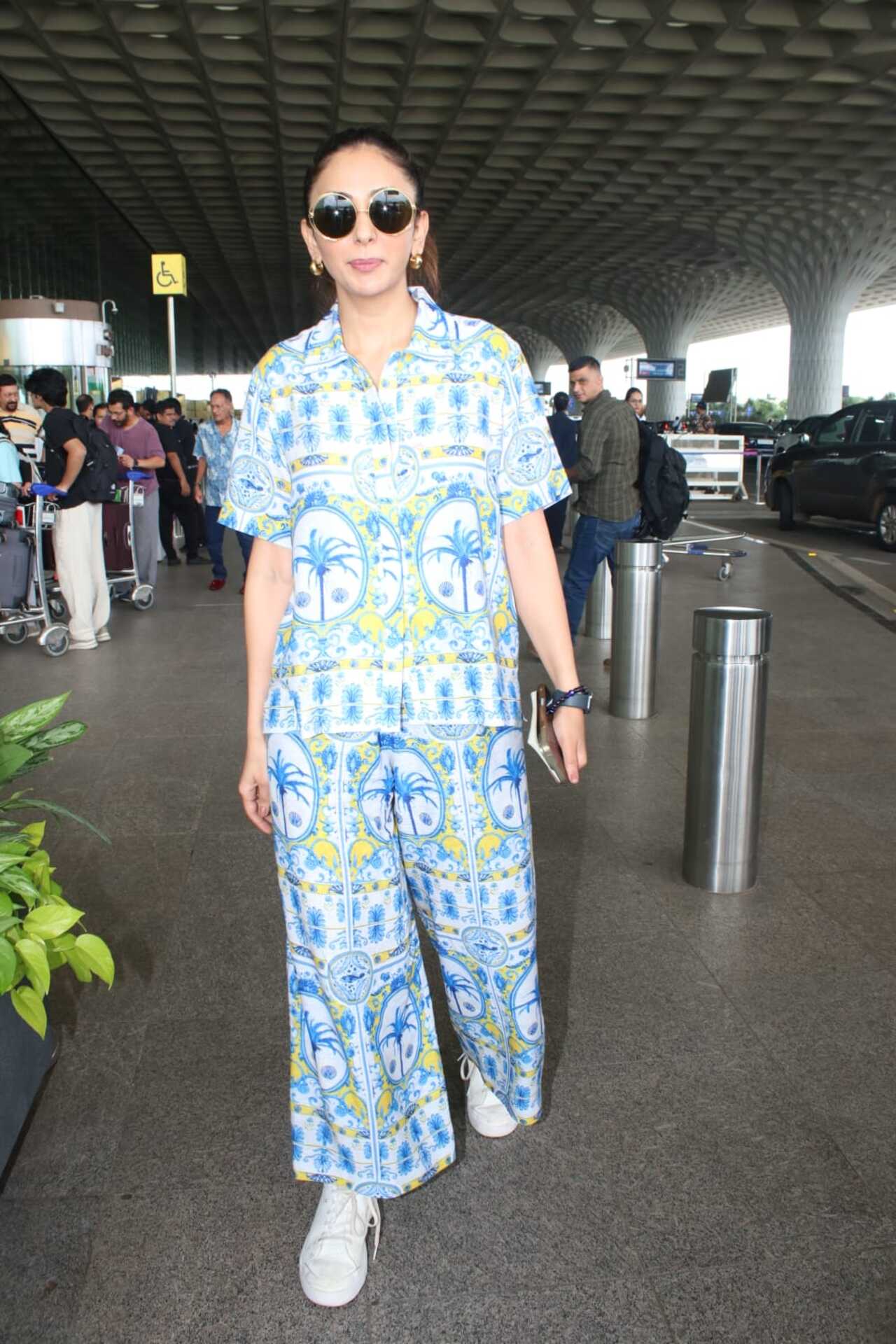 Rakul Preet Singh was spotted at the airport sporting a vibrant and breezy co-ord set featuring tropical prints. She nailed the breezy yet chic look. 